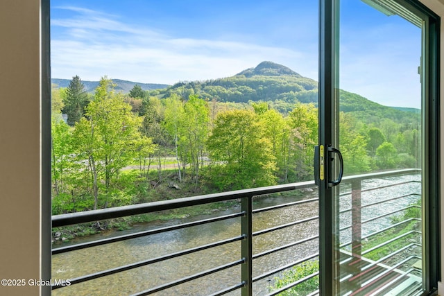 view of mountain backdrop featuring a forest