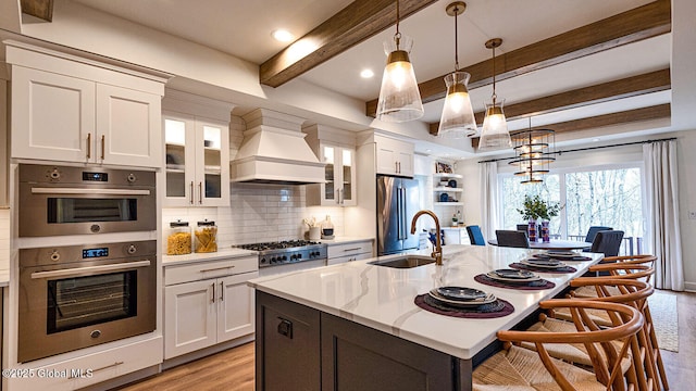 16 Bergen Pl, Niskayuna, NY 12309 - kitchen with a kitchen bar, tasteful backsplash, custom exhaust hood, a sink, and stainless steel appliances