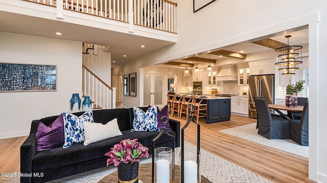 16 Bergen Pl, Niskayuna, NY 12309 - living room featuring light wood-style flooring, baseboards, and stairway