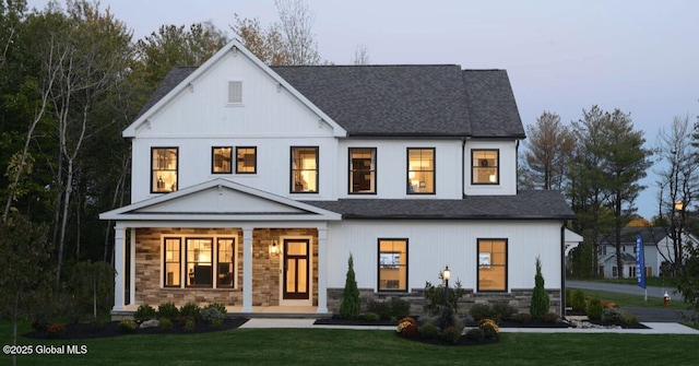 16 Bergen Pl, Niskayuna, NY 12309 - view of front facade featuring a porch, a shingled roof, stone siding, and a front lawn