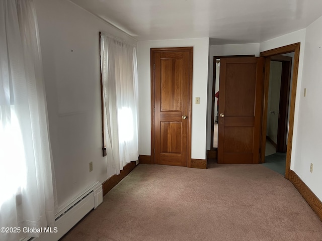 22 Williams St, Whitehall Village, NY 12887 - unfurnished bedroom featuring a baseboard heating unit, baseboards, and carpet