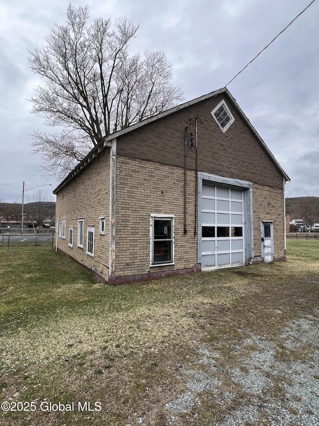 22 Williams St, Whitehall Village, NY 12887 - view of property exterior featuring brick siding, a detached garage, and a lawn