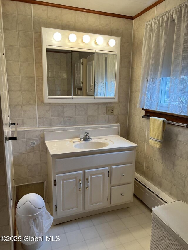 22 Williams St, Whitehall Village, NY 12887 - bathroom with a baseboard heating unit, vanity, tile walls, and crown molding