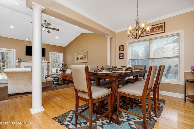 dining space with a wealth of natural light, light wood-type flooring, and ornate columns