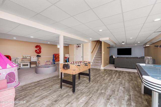 rec room featuring recessed lighting, wood finished floors, and a paneled ceiling