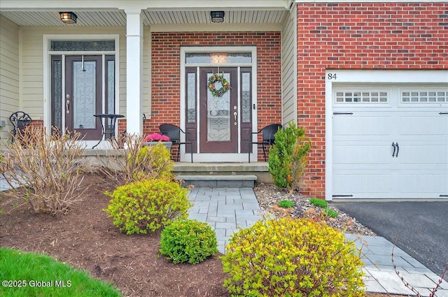 entrance to property with brick siding and a porch