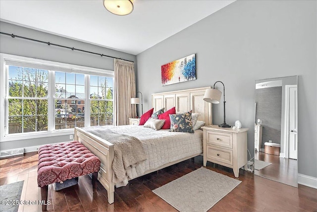 bedroom with baseboards and dark wood finished floors