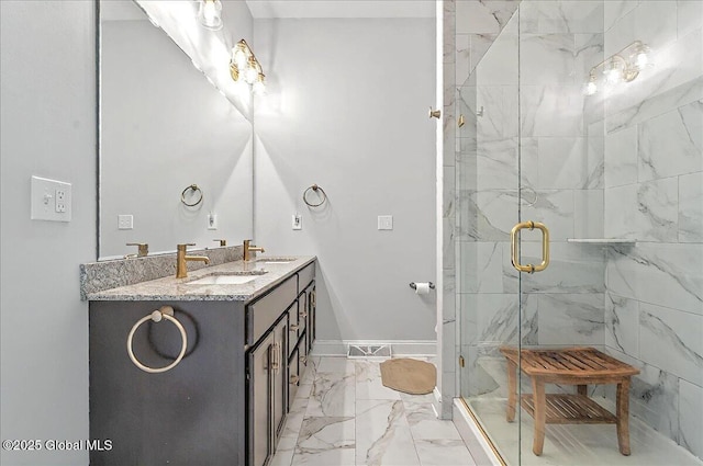 bathroom featuring double vanity, a marble finish shower, a sink, and marble finish floor