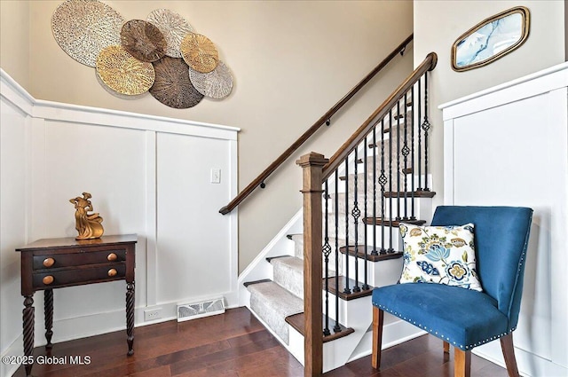 stairway with visible vents and wood finished floors