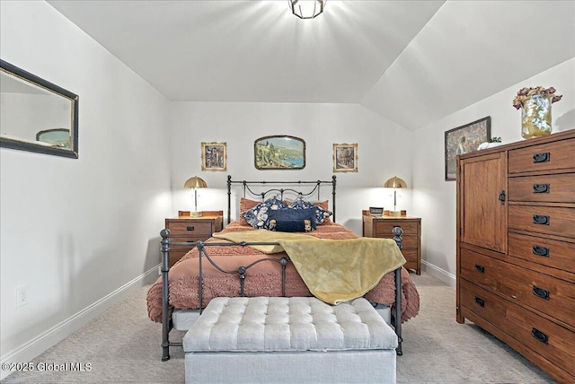 bedroom with light colored carpet, baseboards, and vaulted ceiling