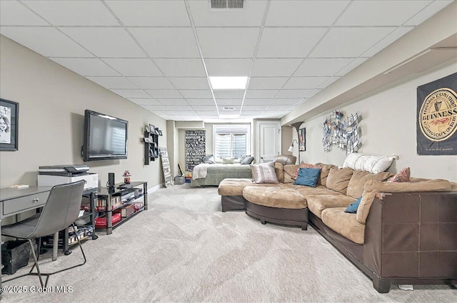 carpeted living area featuring visible vents and a paneled ceiling