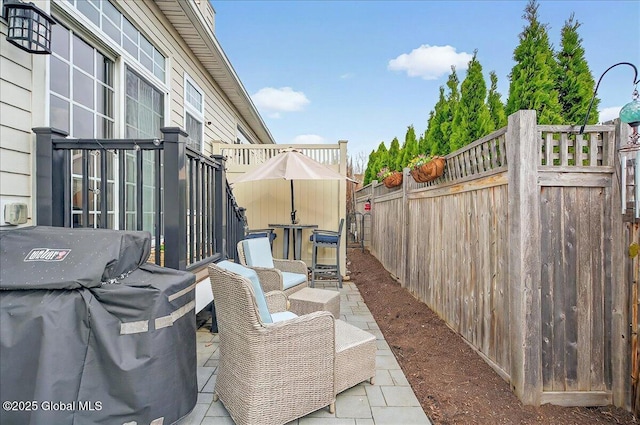 view of patio / terrace with a fenced backyard and a grill