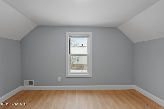 additional living space featuring visible vents, baseboards, and light wood finished floors