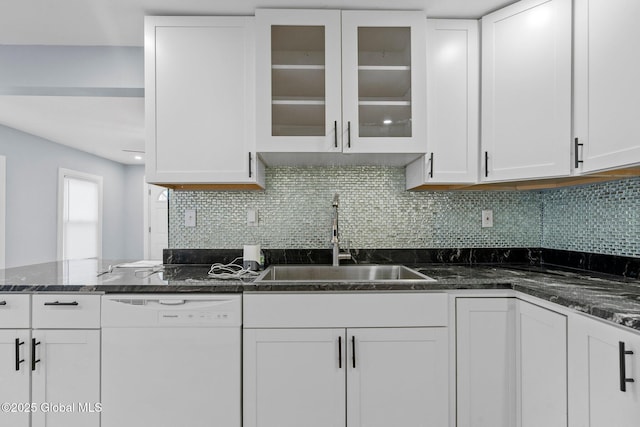 kitchen featuring glass insert cabinets, tasteful backsplash, white cabinetry, dishwasher, and a sink