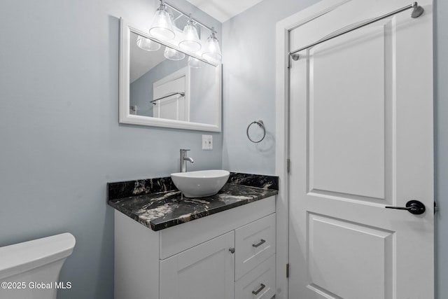 bathroom featuring toilet and vanity
