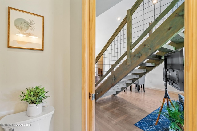 stairway featuring wood finished floors