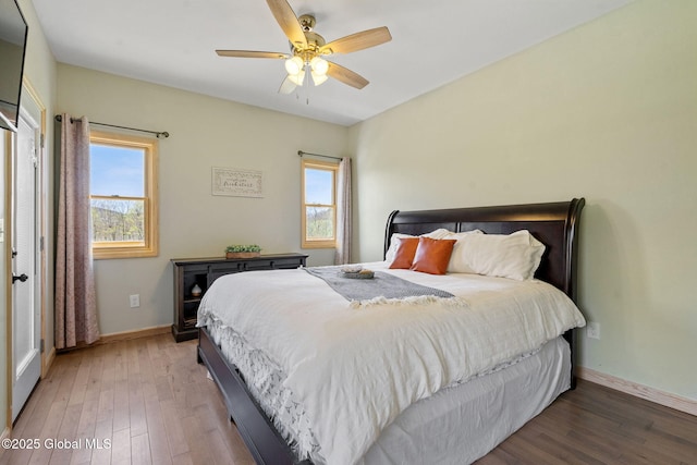 bedroom featuring baseboards, ceiling fan, and wood finished floors