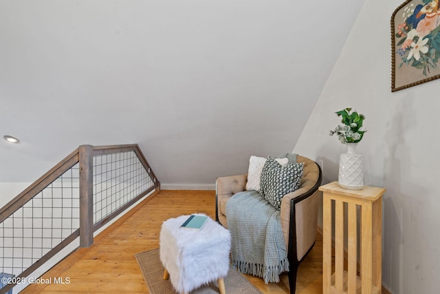 sitting room featuring baseboards and wood-type flooring