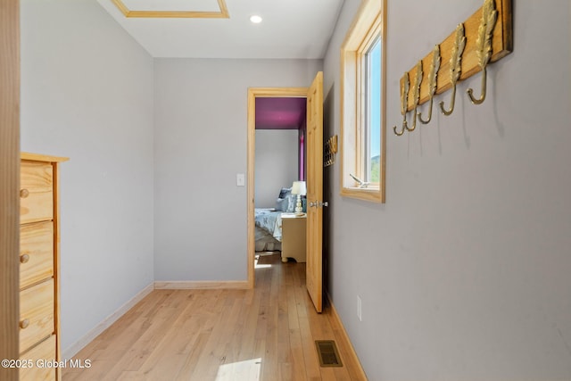 hallway featuring recessed lighting, baseboards, light wood finished floors, and visible vents