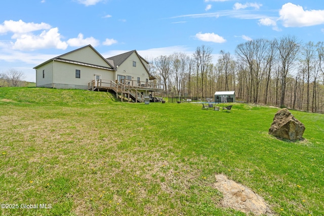 view of yard with a wooden deck and an outdoor structure