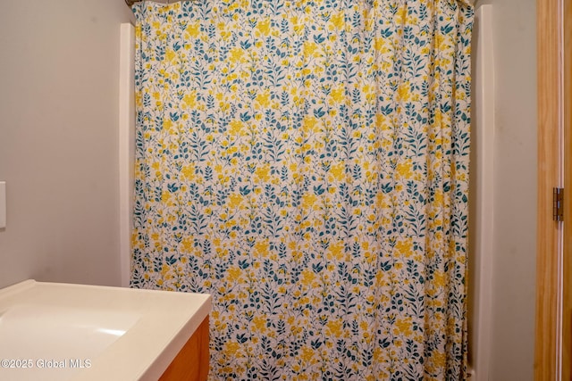 bathroom featuring curtained shower and vanity