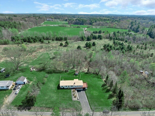 birds eye view of property featuring a rural view and a wooded view