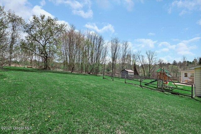 view of yard with a playground and fence