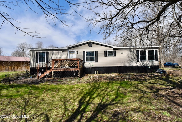 rear view of house featuring a yard and a wooden deck