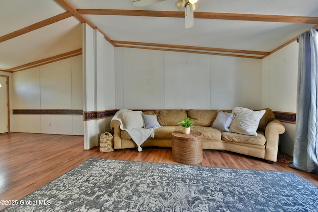living area with wood finished floors, ceiling fan, and lofted ceiling with beams