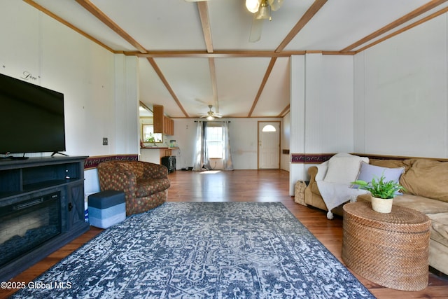 living area with vaulted ceiling with beams, wood finished floors, and ceiling fan
