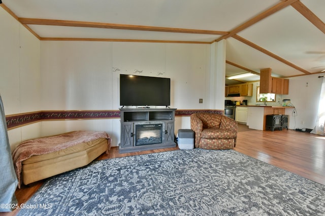 living room featuring vaulted ceiling and wood finished floors
