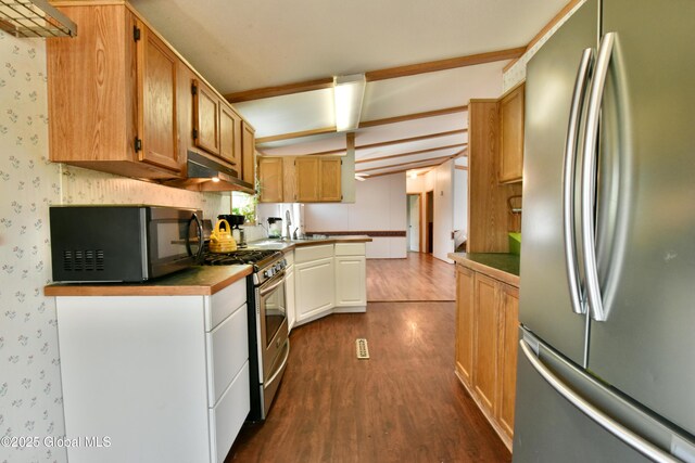 kitchen featuring appliances with stainless steel finishes, dark wood finished floors, under cabinet range hood, beamed ceiling, and wallpapered walls