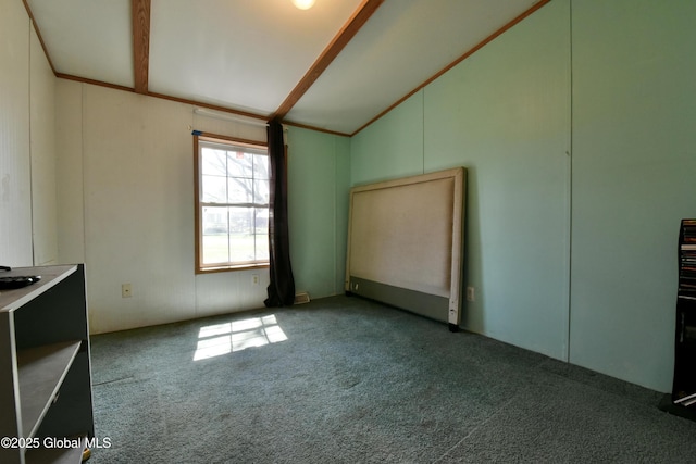 carpeted empty room with lofted ceiling