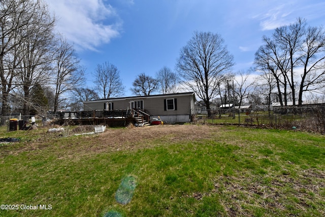 view of yard with a wooden deck and fence