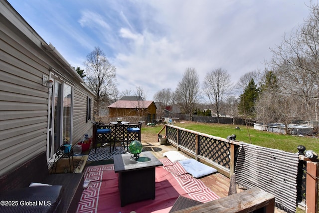 wooden deck featuring an outdoor living space, a yard, a fenced backyard, a patio area, and outdoor dining space