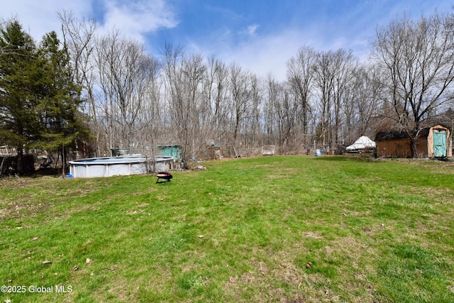 view of yard with an outdoor pool