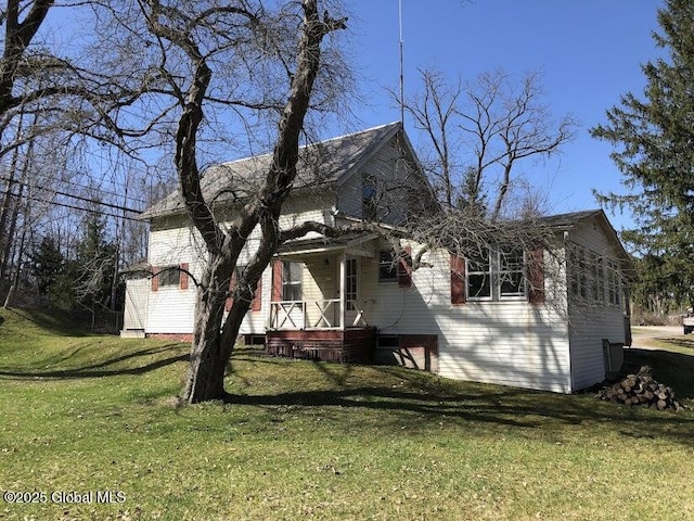 exterior space featuring a porch and a lawn
