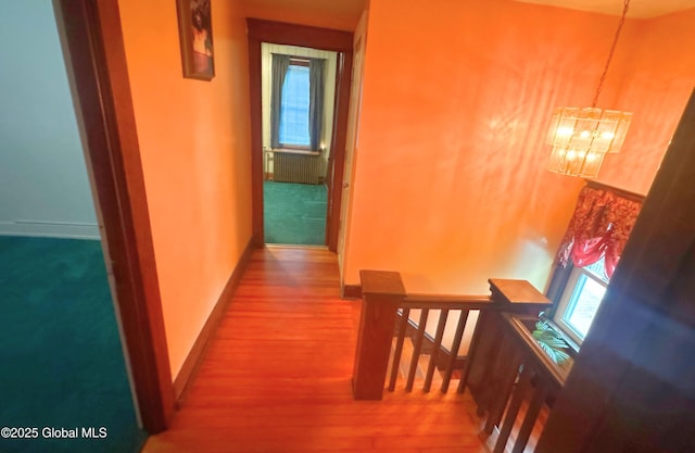 19 Bohl Ave, Albany, NY 12209 - hall featuring baseboards, a notable chandelier, an upstairs landing, and wood finished floors