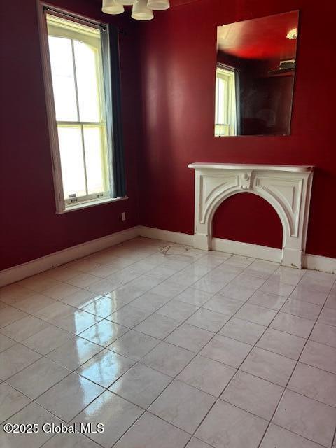 3 Osborne St, Albany, NY 12202 - unfurnished living room featuring a fireplace, light tile patterned floors, and baseboards