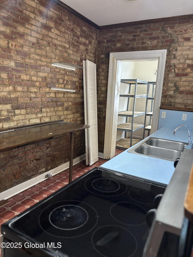 3 Osborne St, Albany, NY 12202 - interior space featuring crown molding, electric stove, a sink, and brick wall