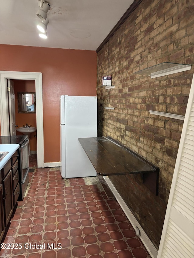 3 Osborne St, Albany, NY 12202 - kitchen with tile patterned floors, stainless steel range with electric cooktop, dark brown cabinetry, baseboards, and freestanding refrigerator