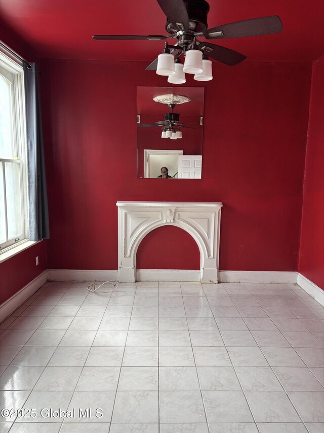 3 Osborne St, Albany, NY 12202 - unfurnished living room featuring baseboards, light tile patterned floors, a ceiling fan, and plenty of natural light