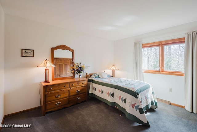 bedroom with baseboards, visible vents, and dark colored carpet