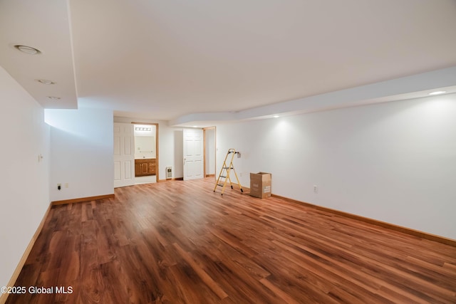 finished basement featuring baseboards and wood finished floors