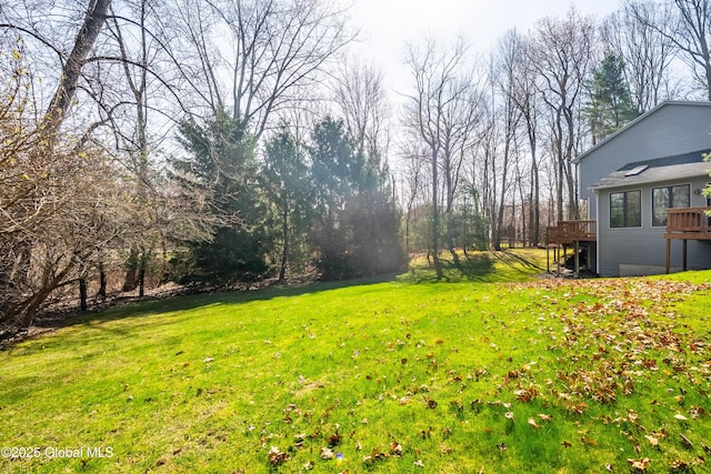view of yard featuring a wooden deck