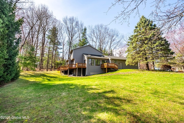 back of property with a lawn and a deck