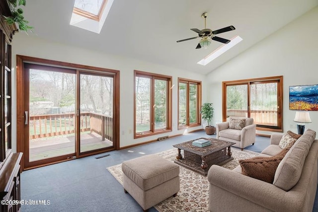 living area featuring carpet, a healthy amount of sunlight, and a skylight