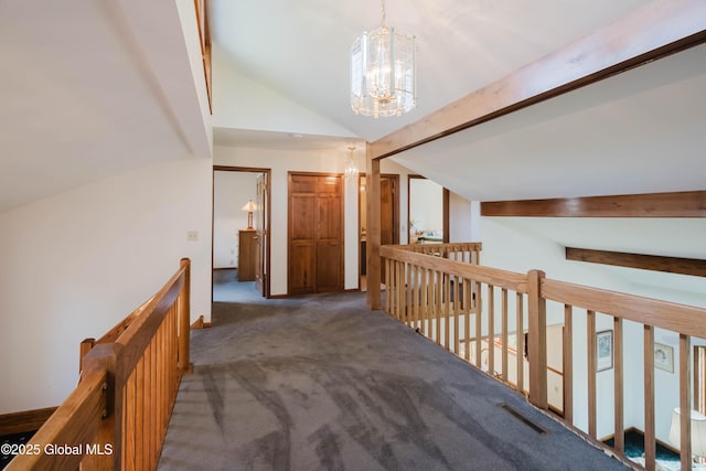 corridor featuring carpet floors, lofted ceiling, a chandelier, and an upstairs landing