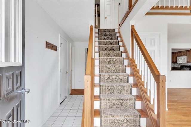 stairway featuring tile patterned floors