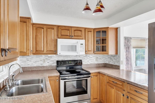 kitchen featuring electric range, glass insert cabinets, white microwave, a textured ceiling, and a sink